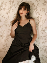 A girl wears a black midi dress